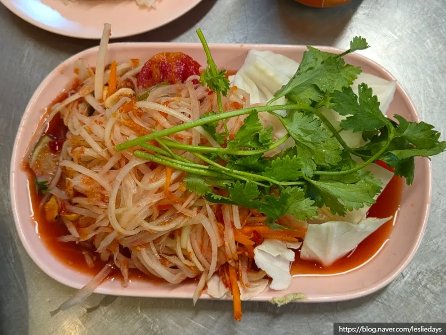 Close-up of som tam sprinkled with peanut powder
