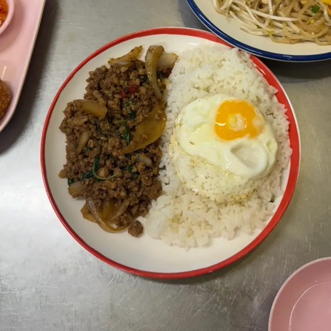 A bite of noodles lifted from the pad thai
