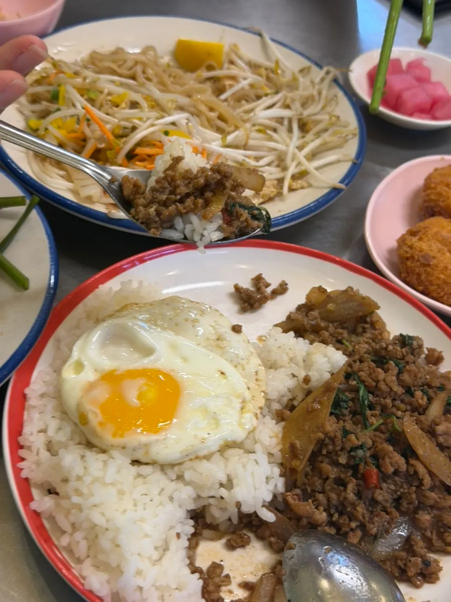 Pad kra pao moo saap topped with a soft fried egg