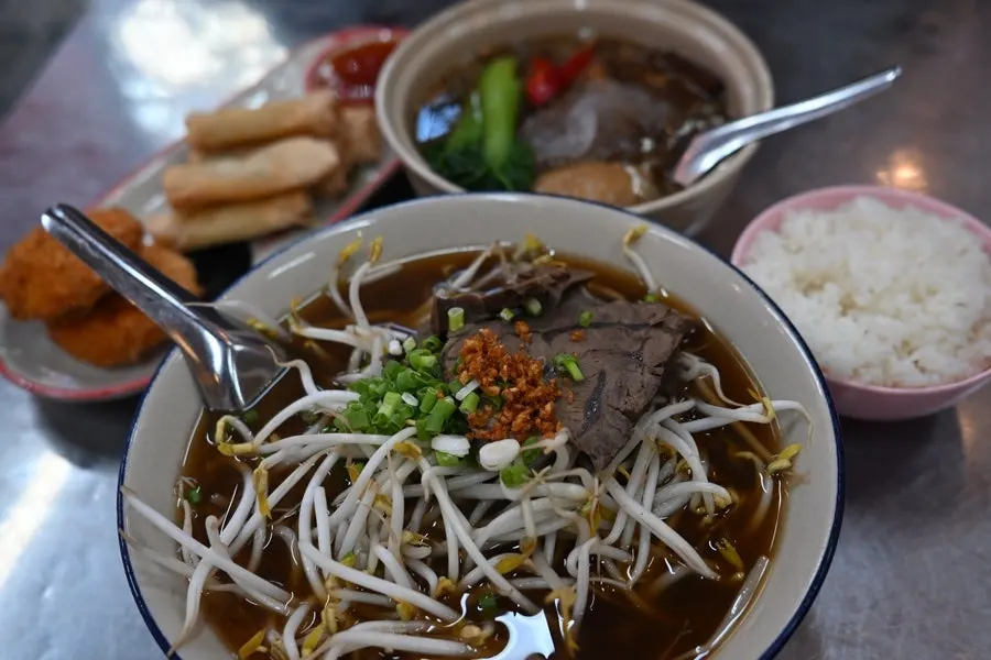 A bowl of beef pho with rich broth