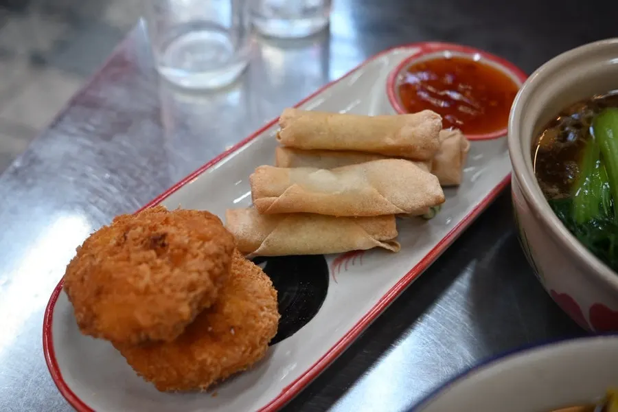 Side orders of half spring rolls and half tod mun goong