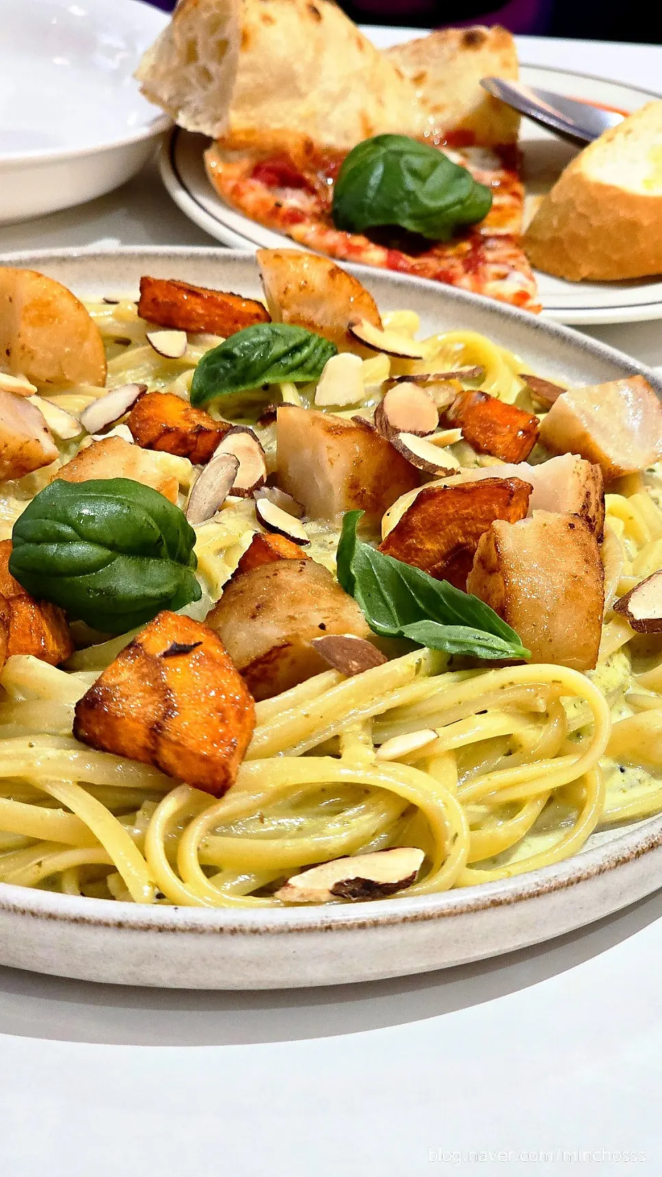 Basil cream linguine topped with large scallops