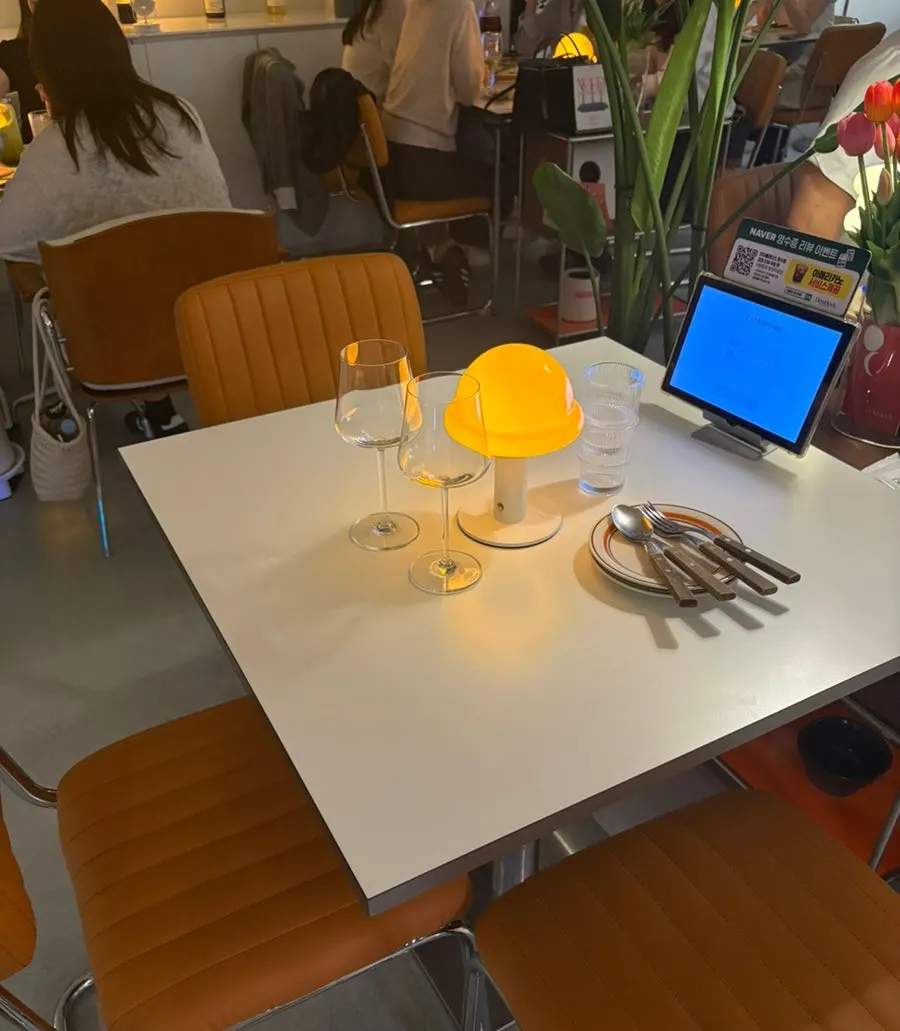 Seated table with mushroom-shaped yellow lighting