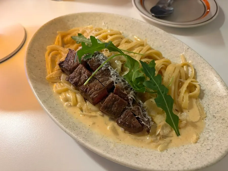 Close-up of the cream pasta ordered at a mildly spicy level