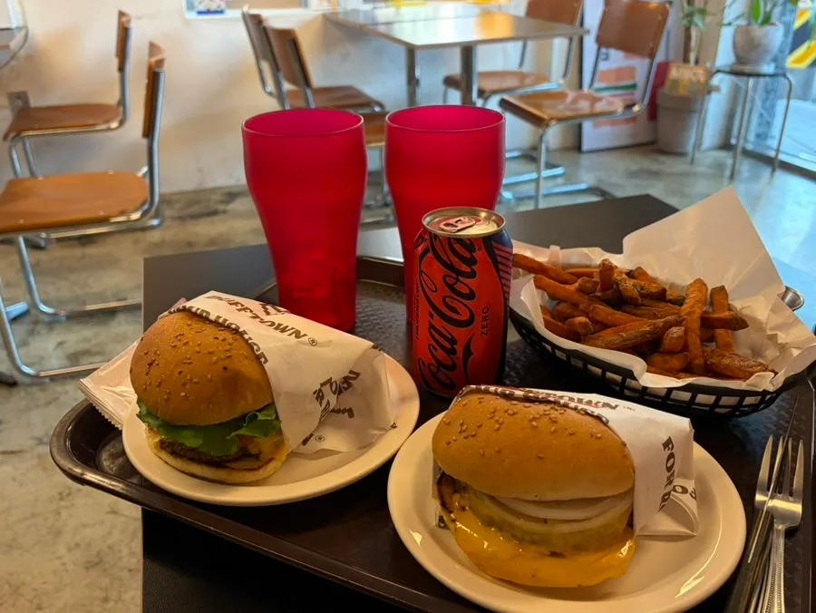 Two burgers and a Zero Coke lined up neatly on the table
