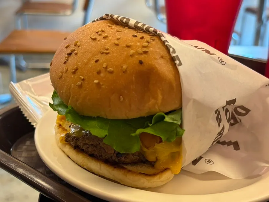 Classic Deluxe burger showing the patty and bacon
