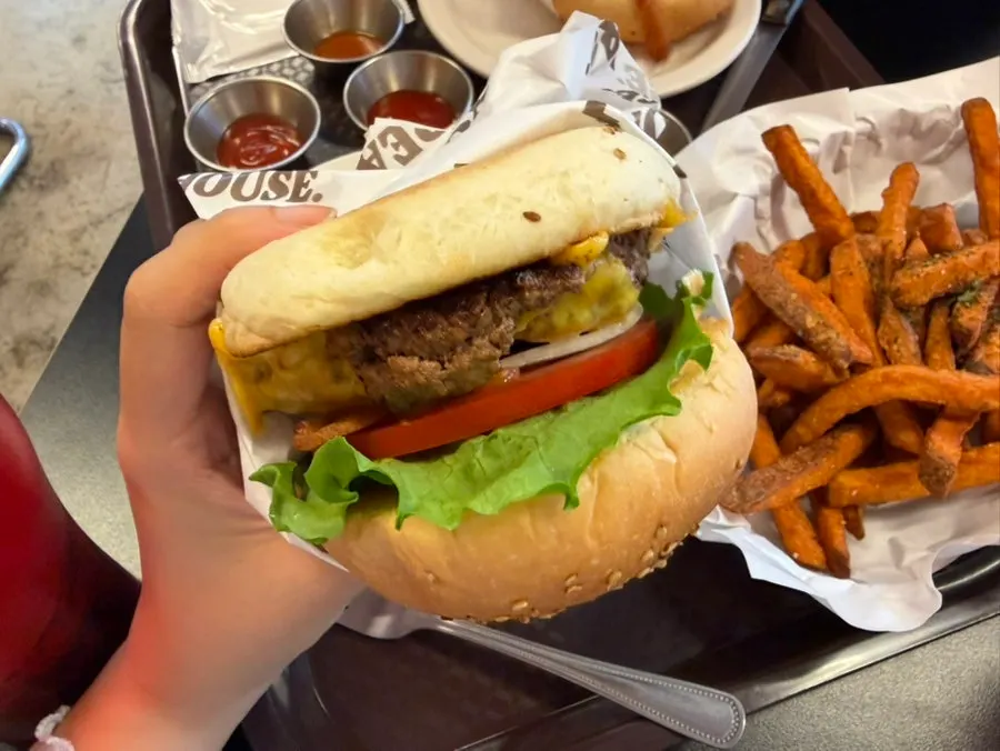 Classic Deluxe burger held upside down