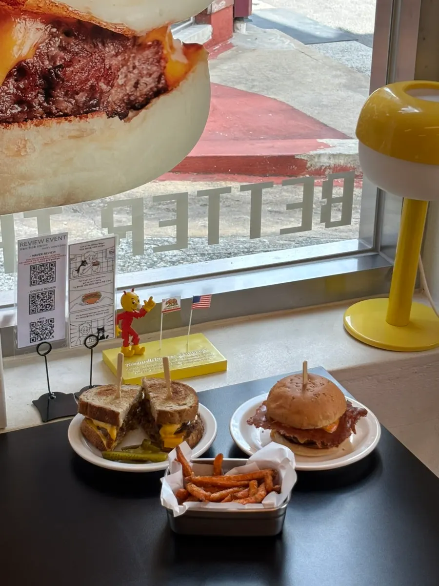 Burger flipped upside down with a side dish