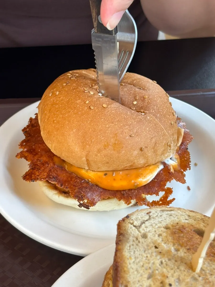 Close-up of a Dufftown burger dripping with sauce
