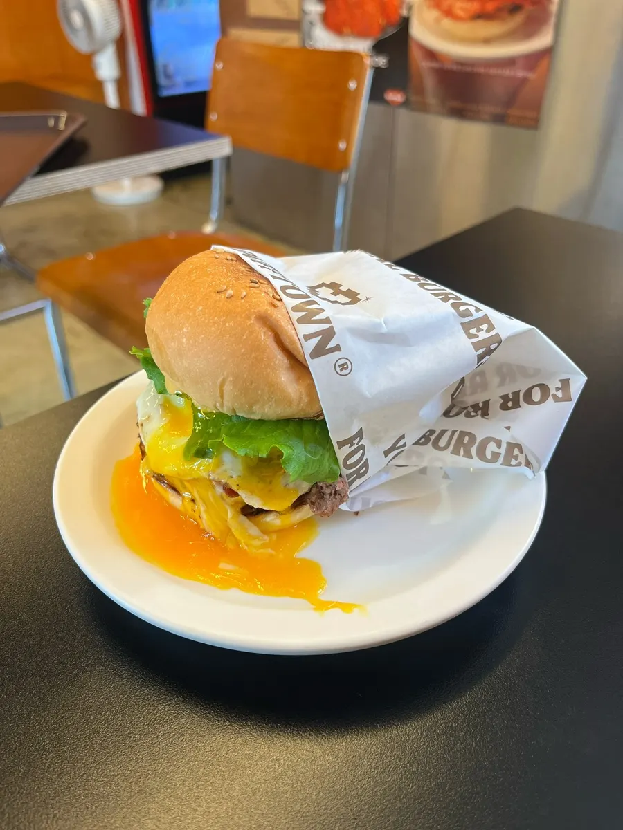 Hand-patty burger with American cheese and crispy bacon
