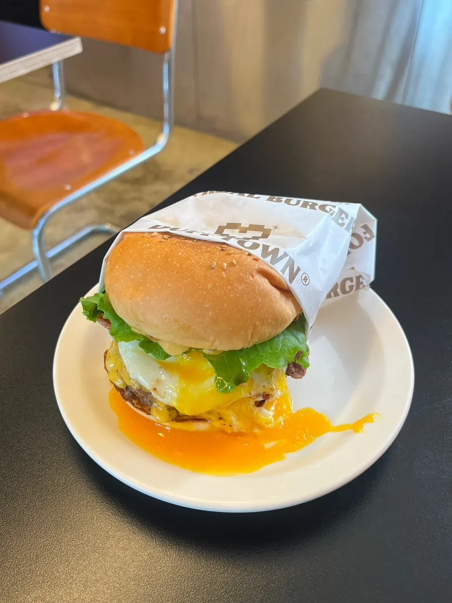 Cross-section of the burger showing a thick patty and vegetables