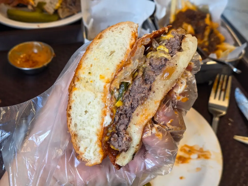 Cross-section of the cheese skirt burger showing the thick patty