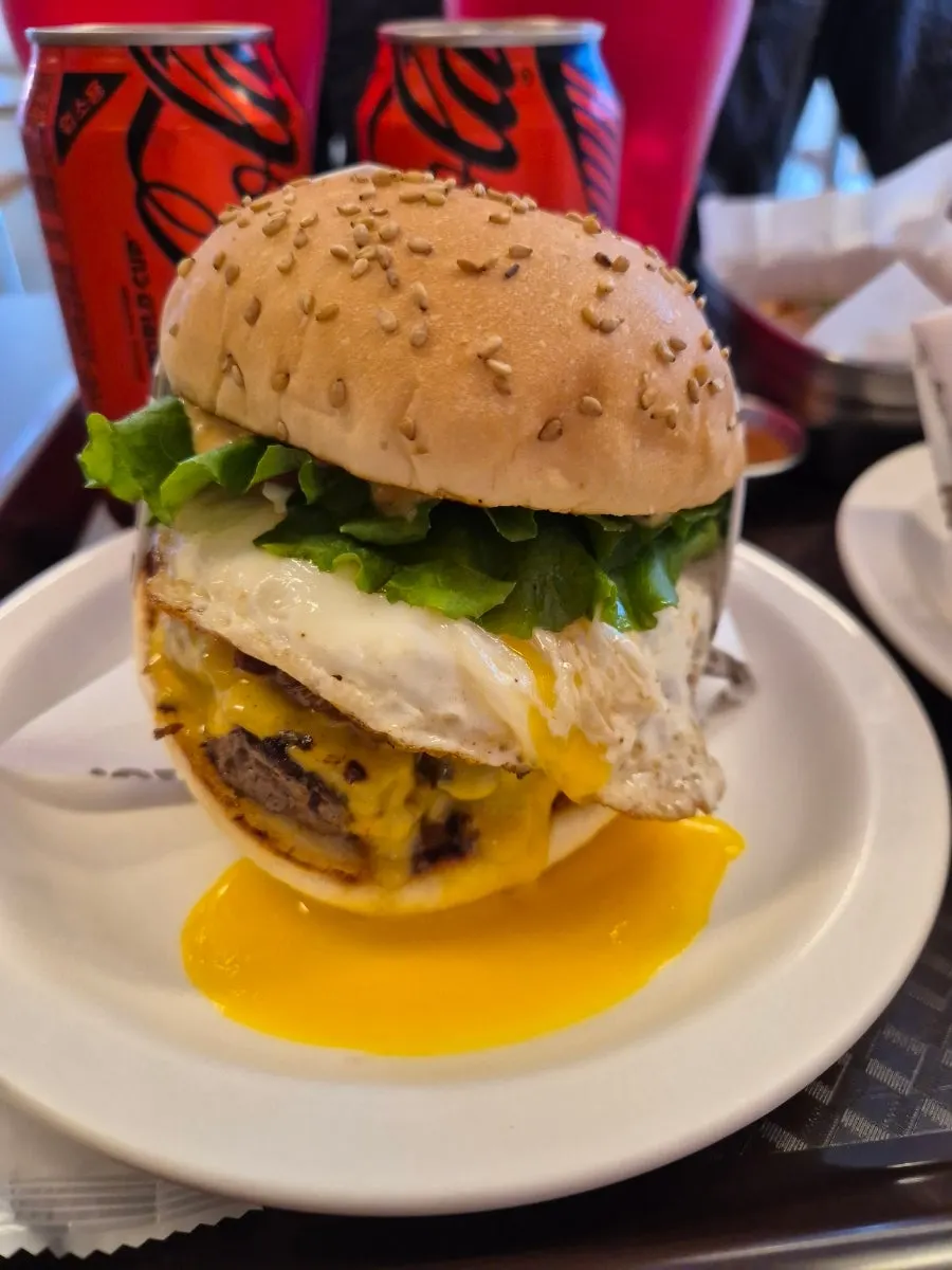 Dufftown & Dancing burger with egg yolk dripping down