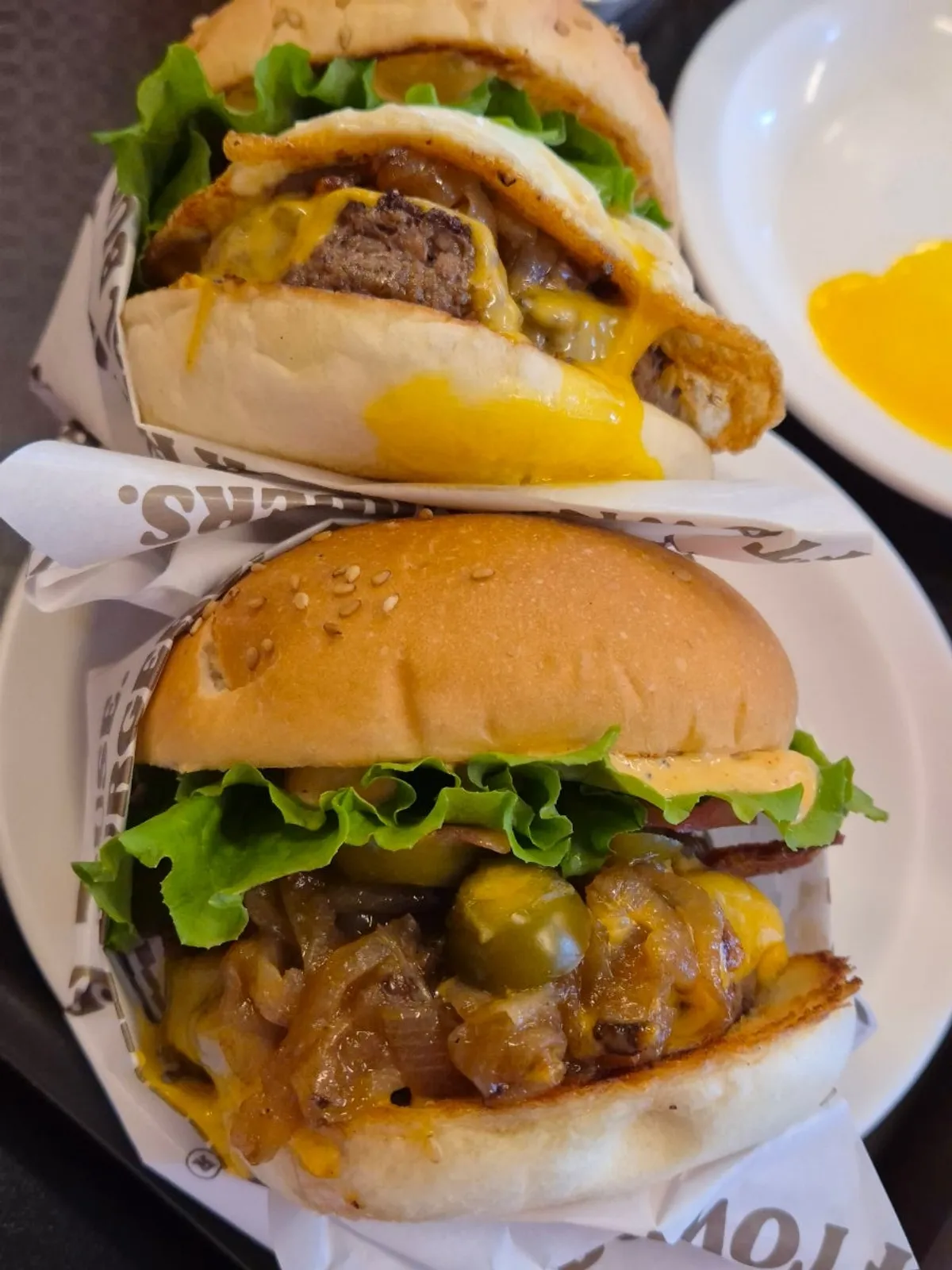 A handmade Dufftown burger held up close