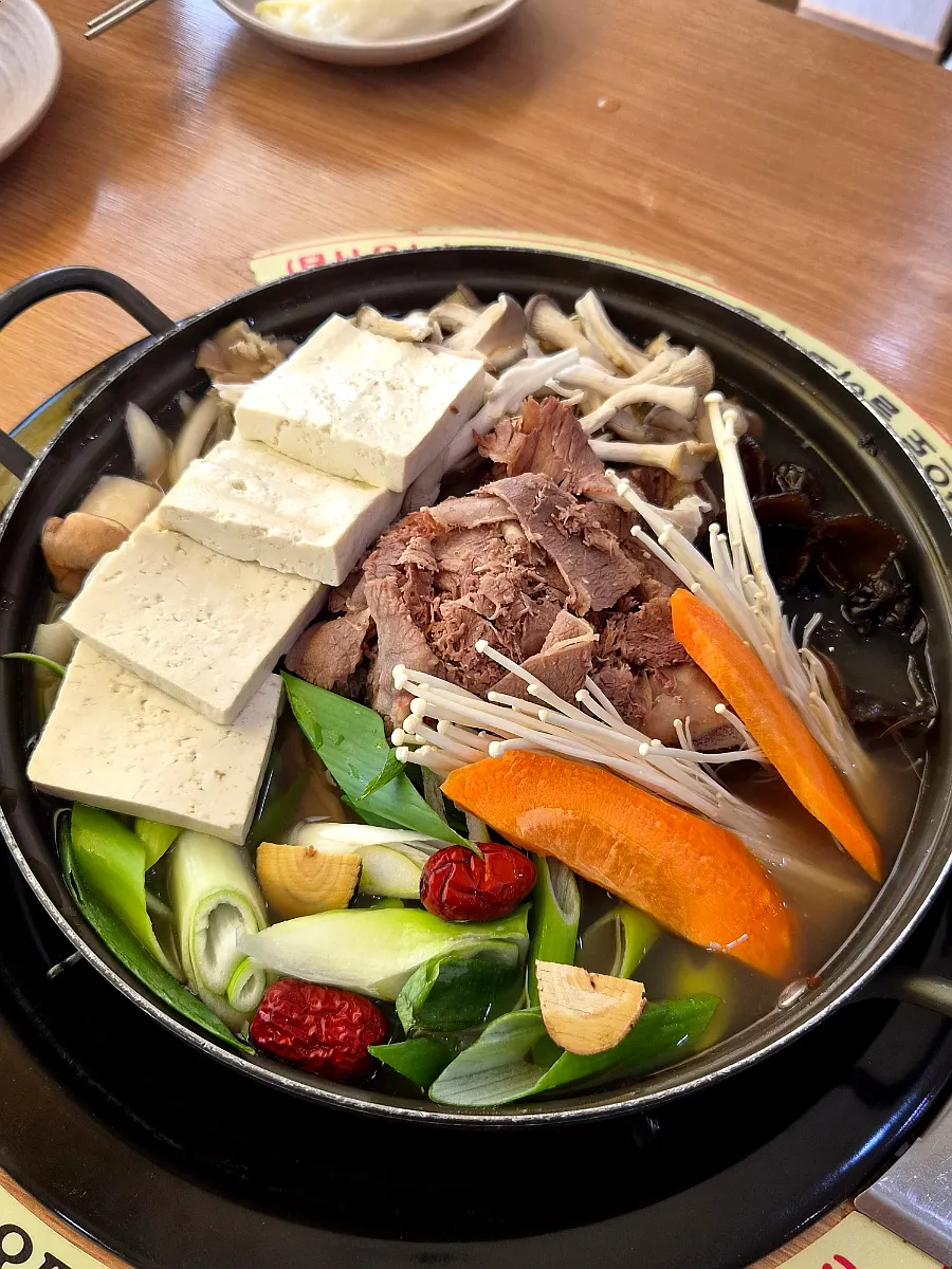 Pot of teukjeon-gol filled with beef and mushrooms