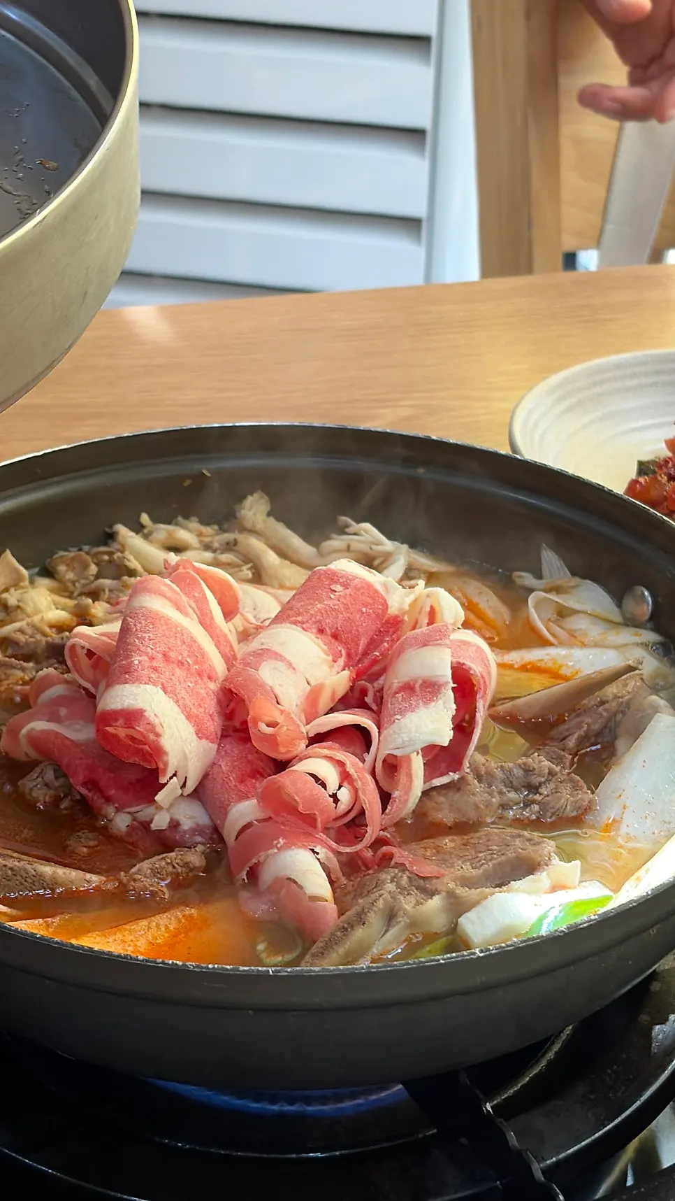 Two servings of usinjeongol boiling with shabu-style beef