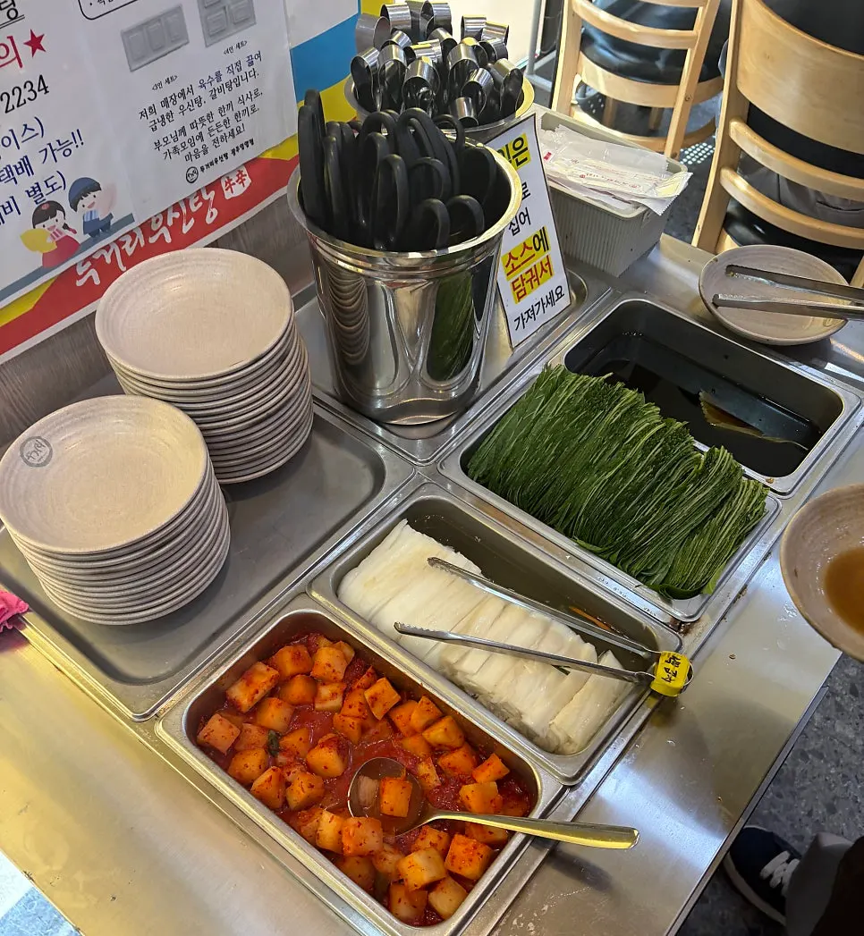 Self-serve corner with white kimchi and diced radish kimchi
