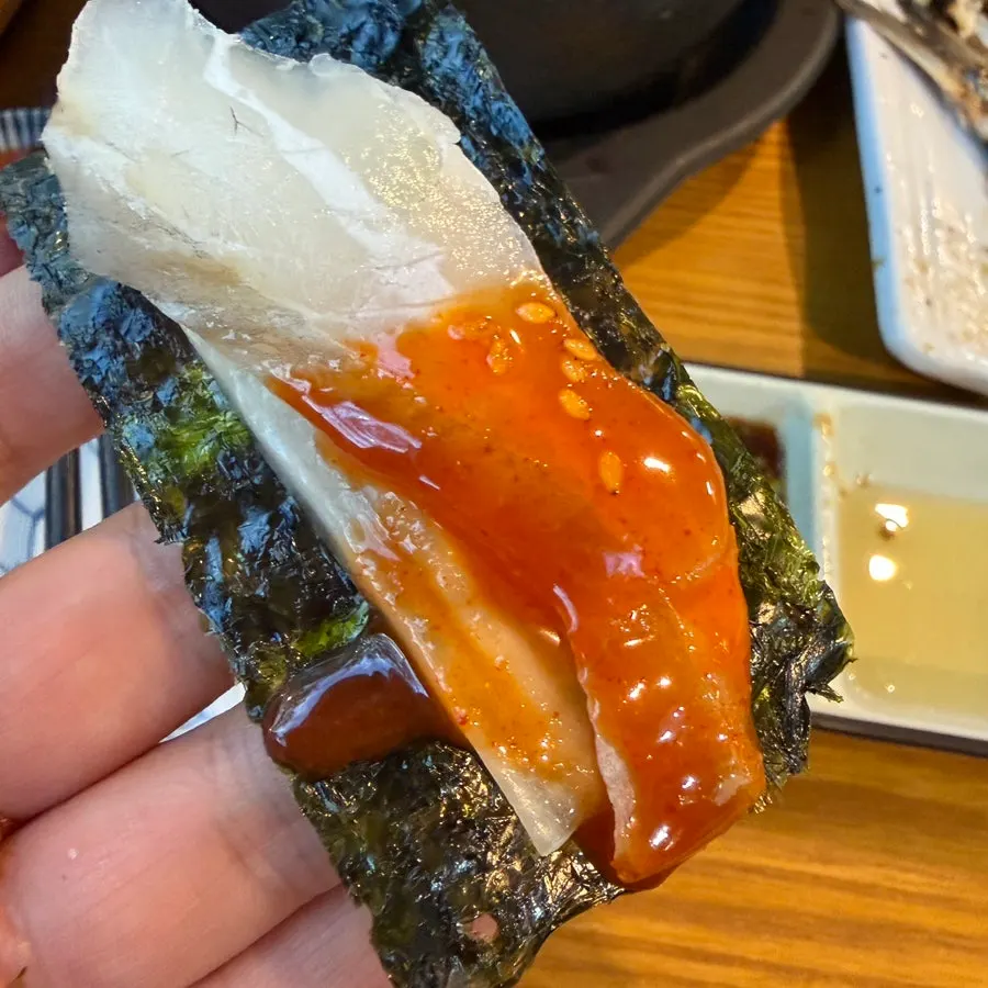 Gim and seasoning sauces served alongside the sashimi