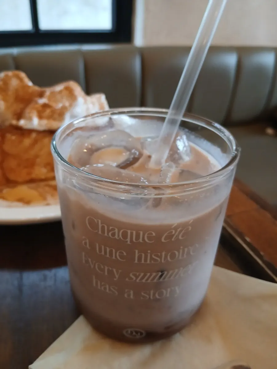 A cup of milk tea topped with rose cream