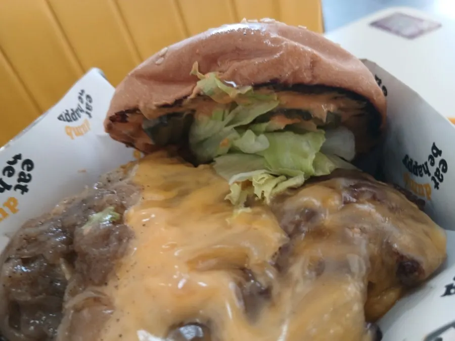 A bite taken out of the double Deom Burger