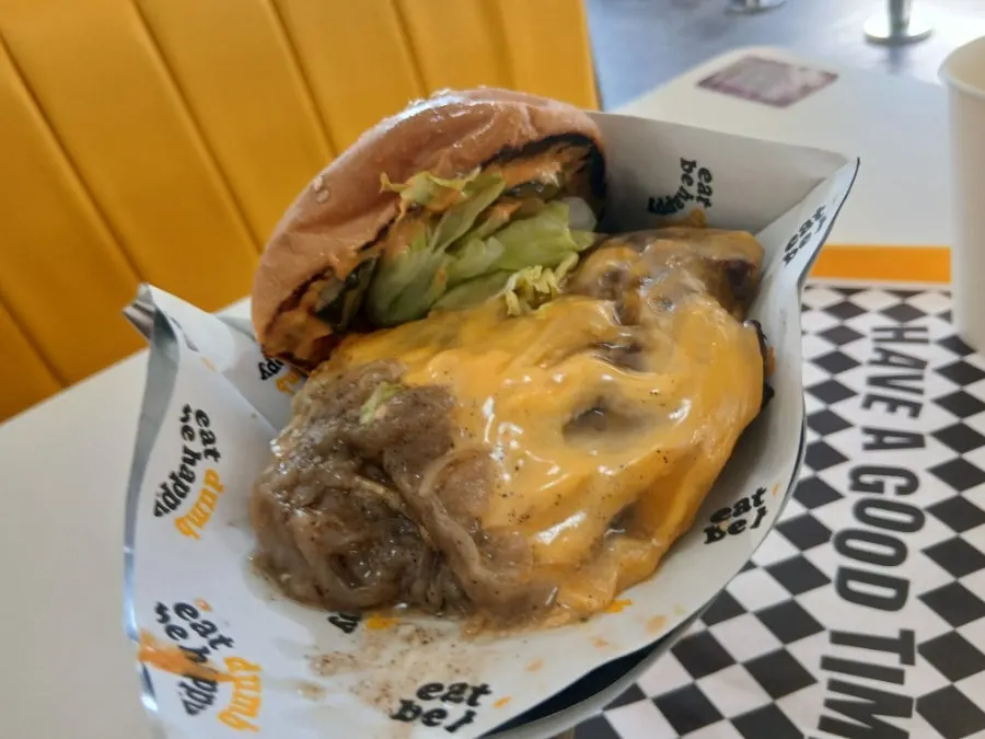 Bun, patty and vegetables combined in the double Deom Burger