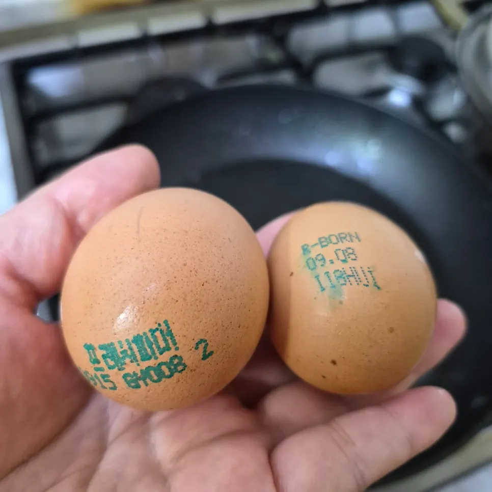 Thick, gathered egg white cracked into a pan
