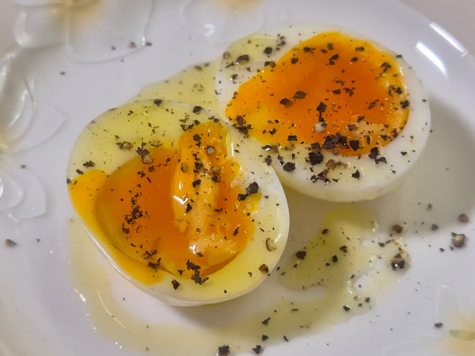 Deep orange yolk of the soft-boiled free-range fertilized egg