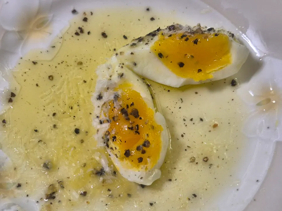 Soft-boiled egg topped with Grana Padano cheese