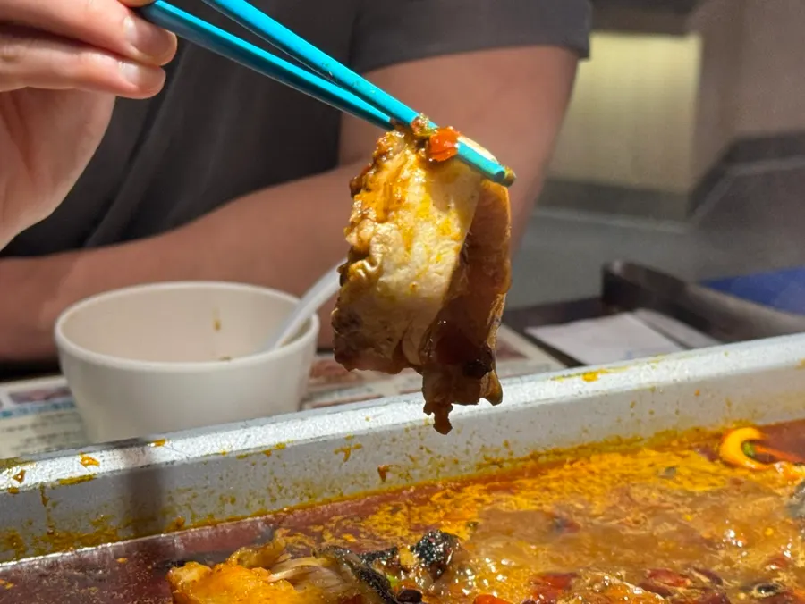 A piece of kaoyu fish soaked in mala sauce