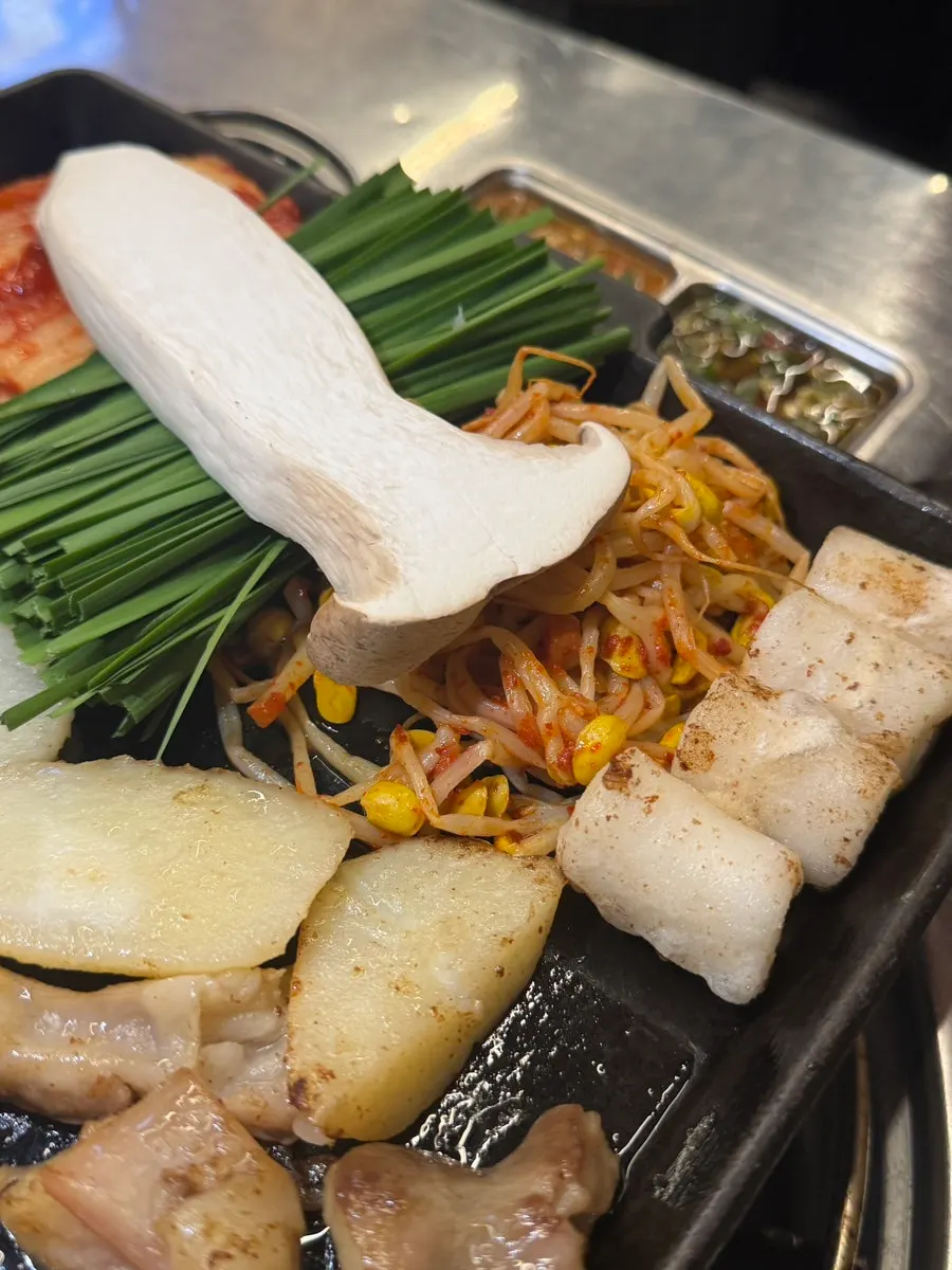 Assorted gopchang being grilled by a staff member