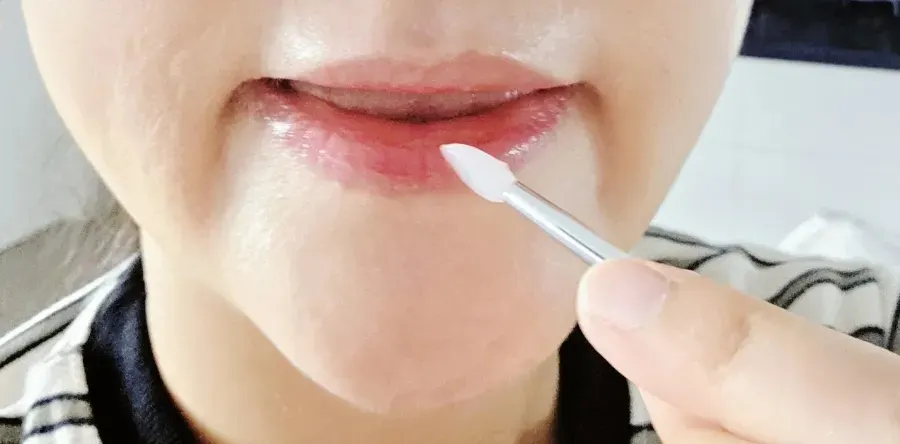 Using lip care before lip makeup