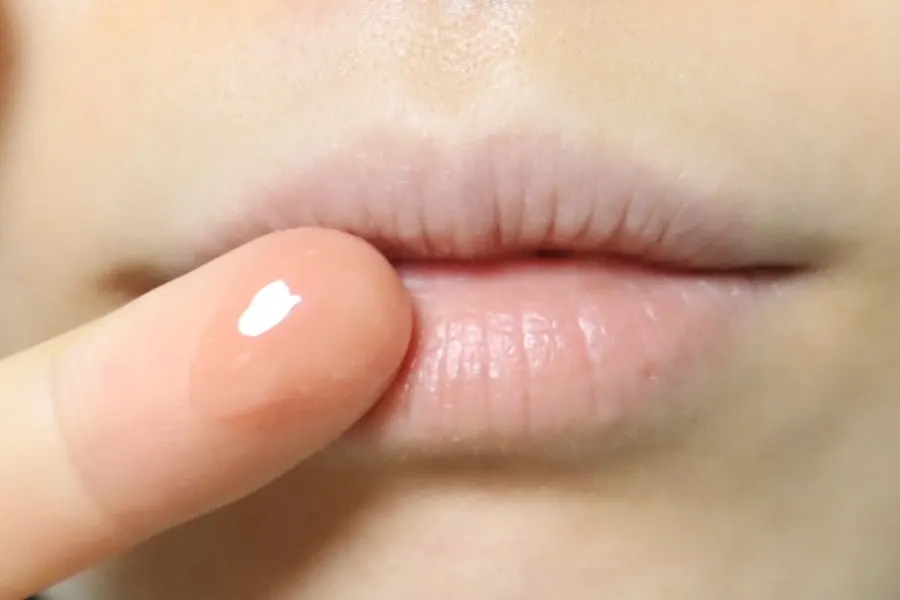 Melting the lip mask between fingers before application