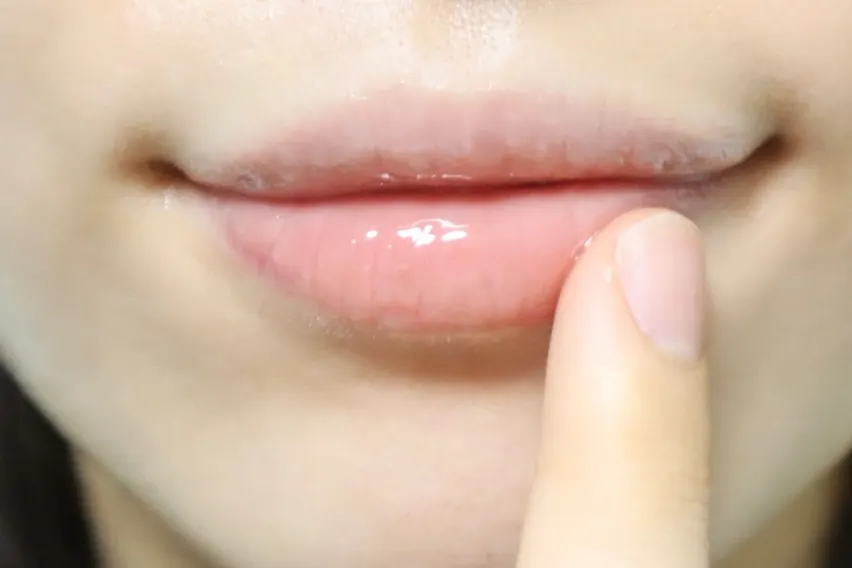 Lips with a thick layer of lip mask