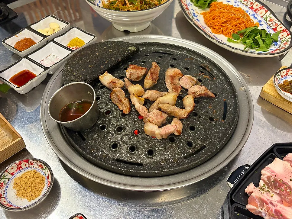 Rare cuts of pork browning on the grill