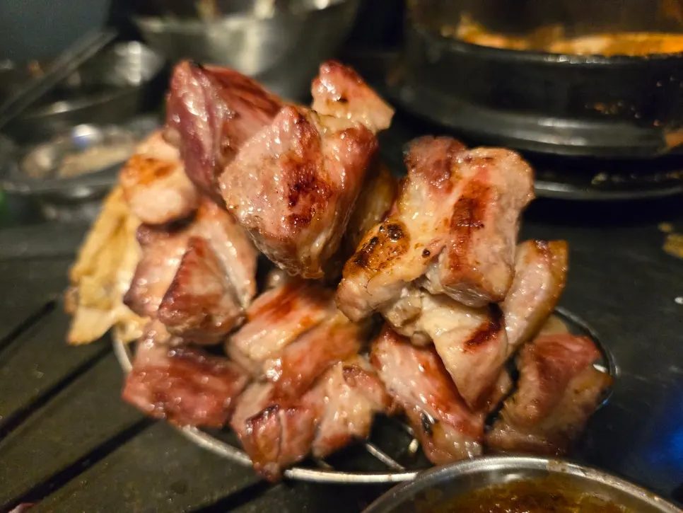Jeju pork grilling alongside a beer