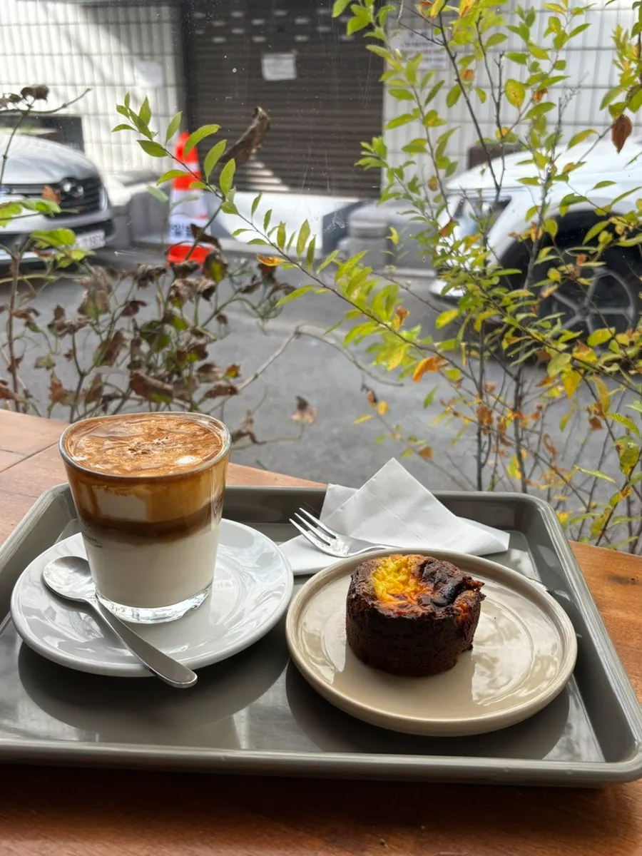 Cream almond latte and egg tart set on a table