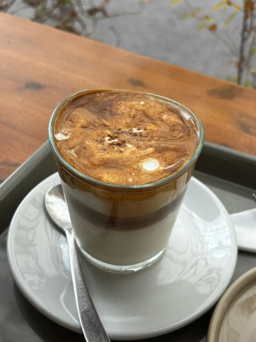 Signature cream almond latte topped with cream
