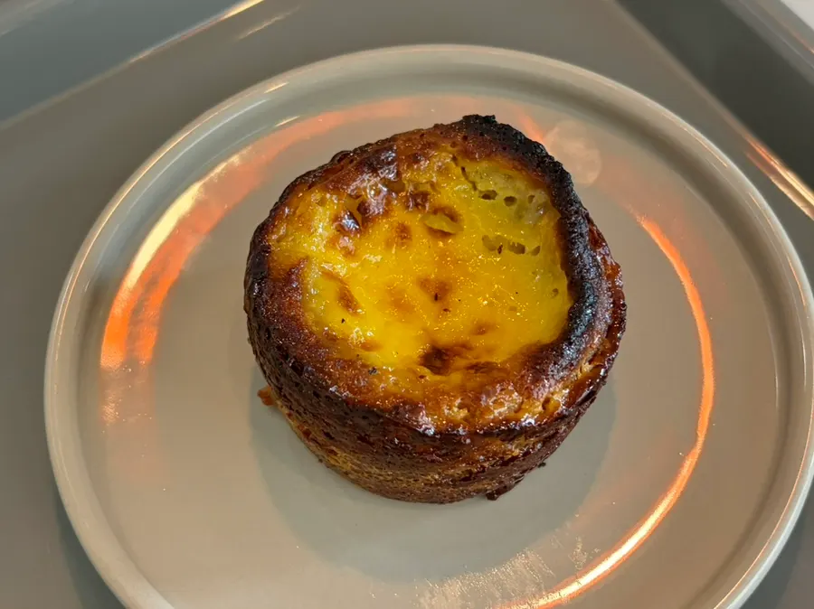 Drinks and a plate of egg financier on the table