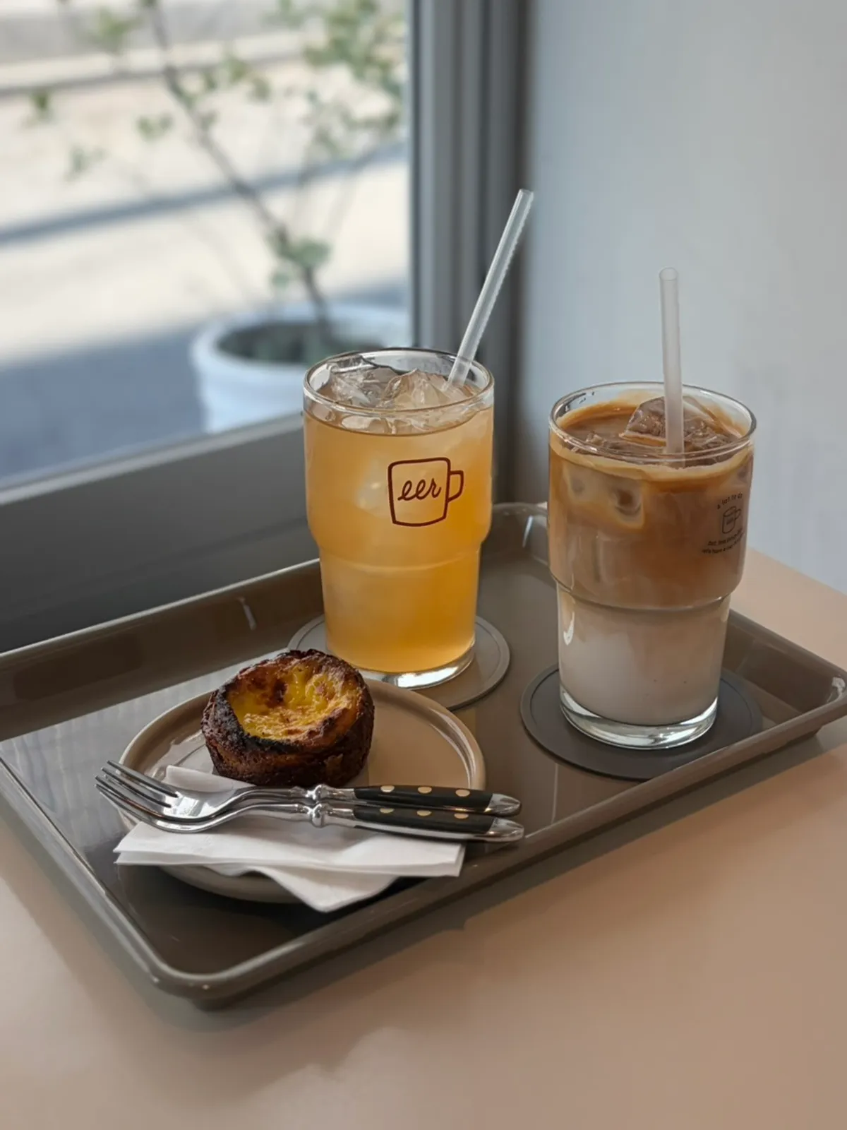 Drinks and dessert set by the window seat