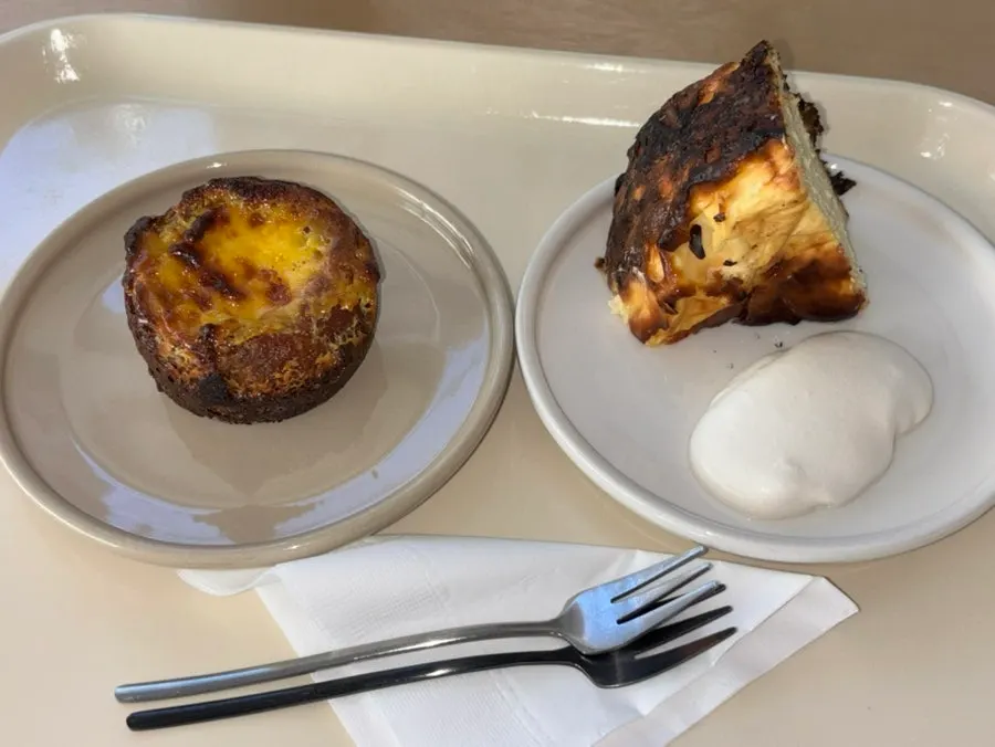 Two dessert plates served alongside coffee