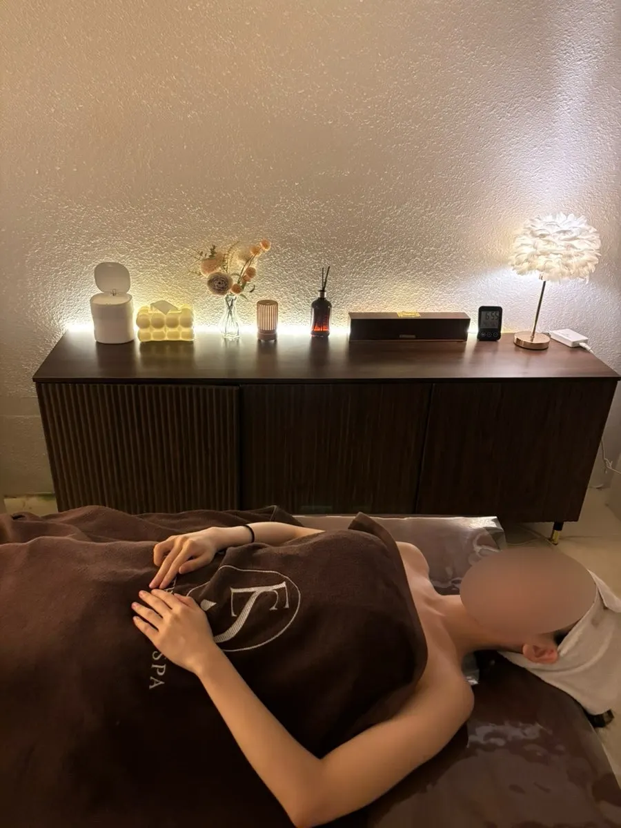 Facial care products set up on the treatment bed