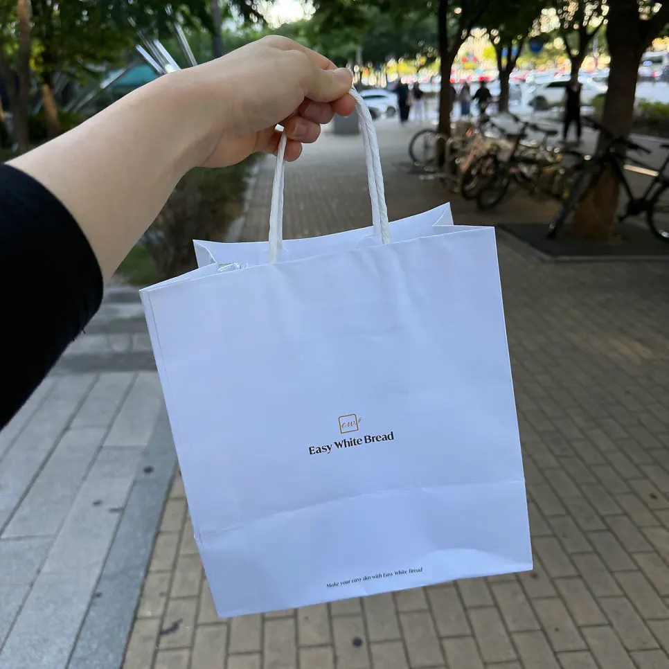Bag with packaged milk bread and cream cheese purchases