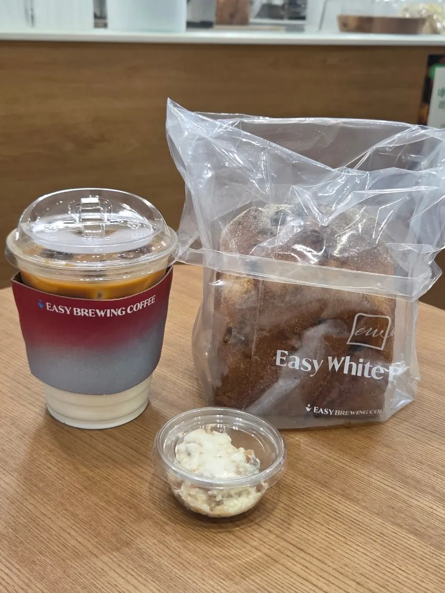 Table setting of walnut cranberry rye milk bread, fig cream cheese, and Easy Latte