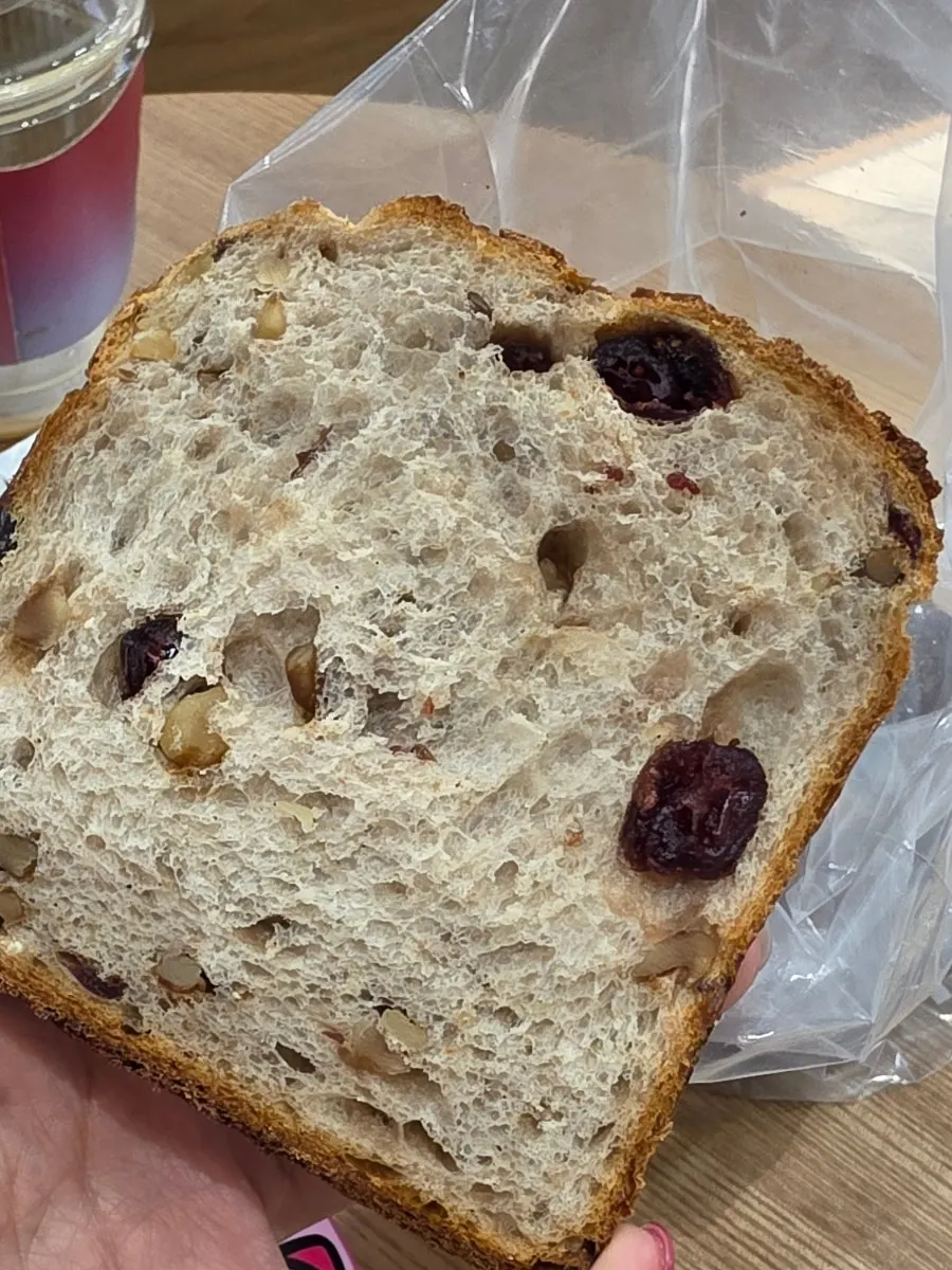 Cross-section of the rye milk bread studded with walnuts and cranberries