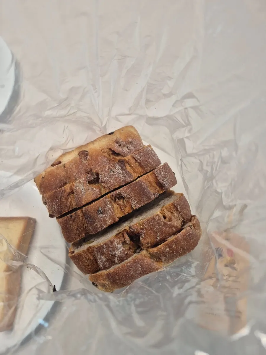 Sliced piece of walnut cranberry rye milk bread