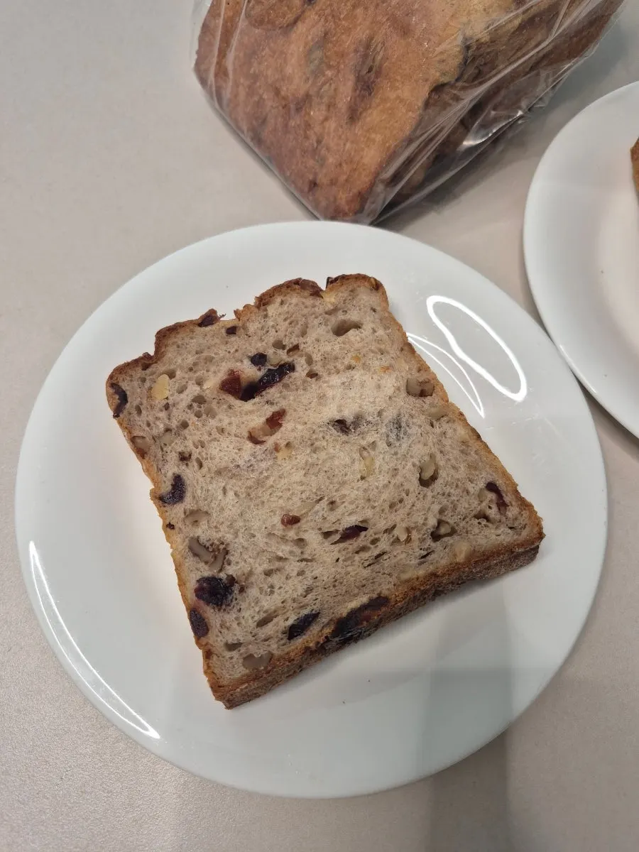 Close-up of the crumb texture of the walnut cranberry rye milk bread