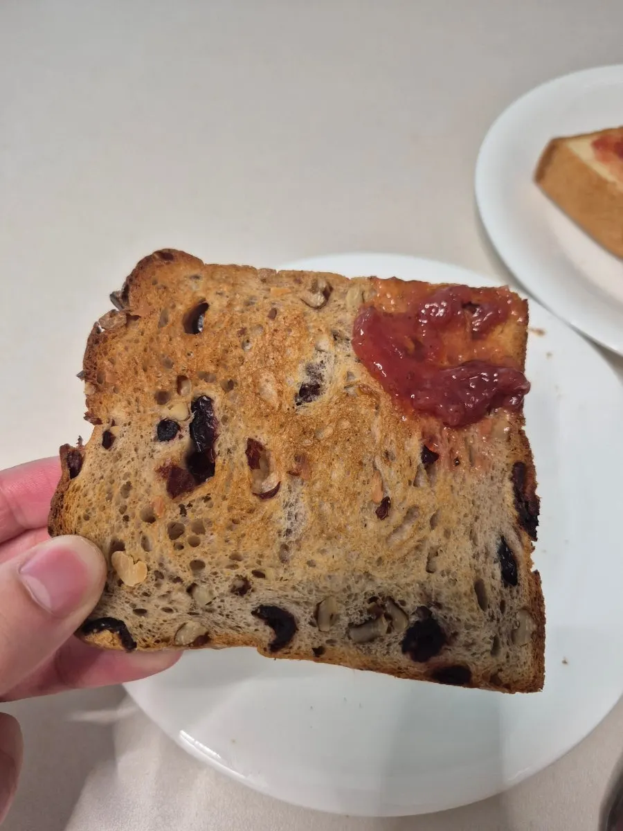 A toasted piece of bread with brewed coffee