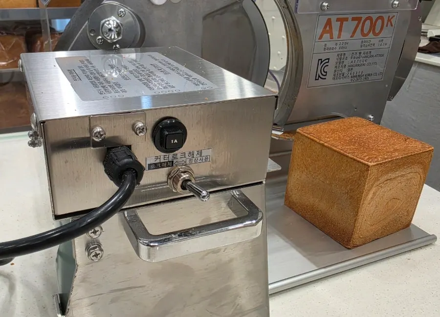 Milk bread being sliced with a dedicated cutting machine
