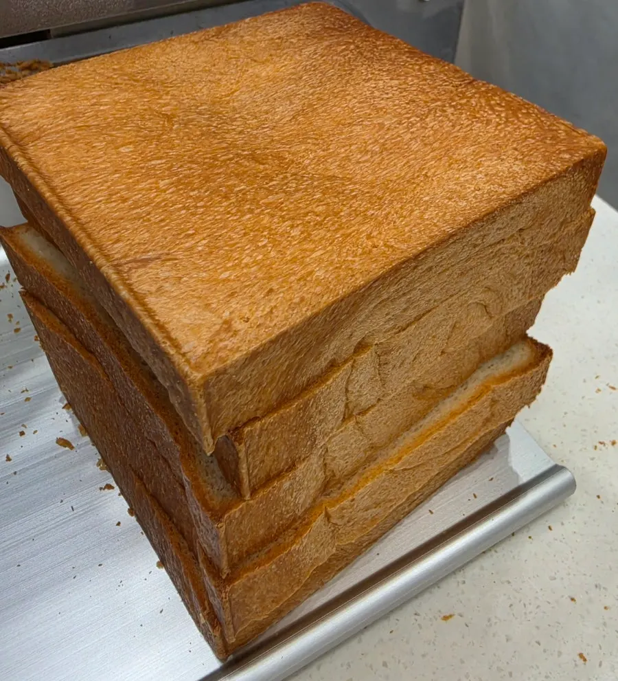 Sliced milk bread being prepared for packaging
