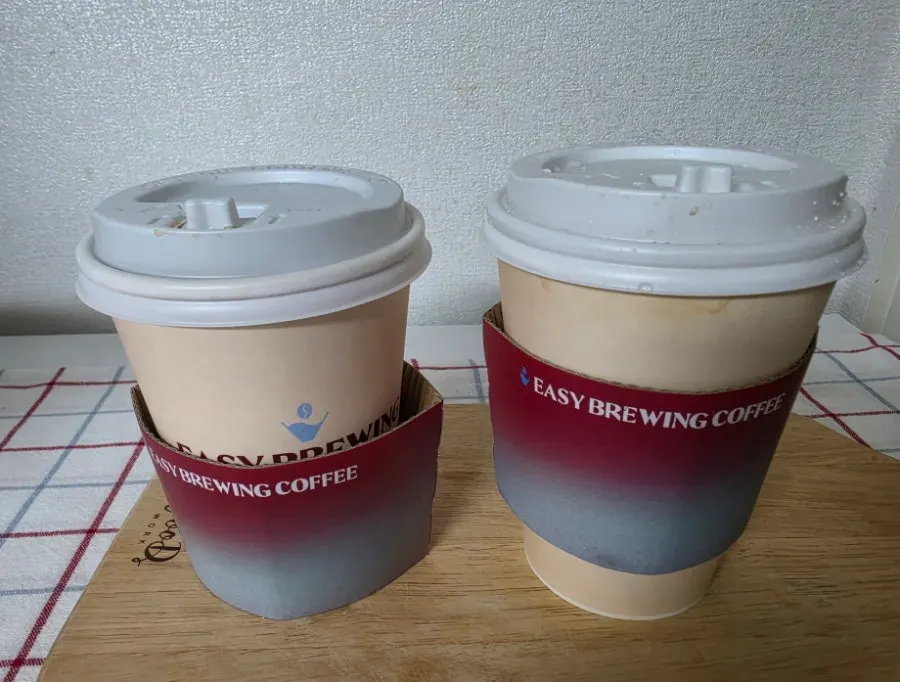 Two brewed coffees in takeout cups